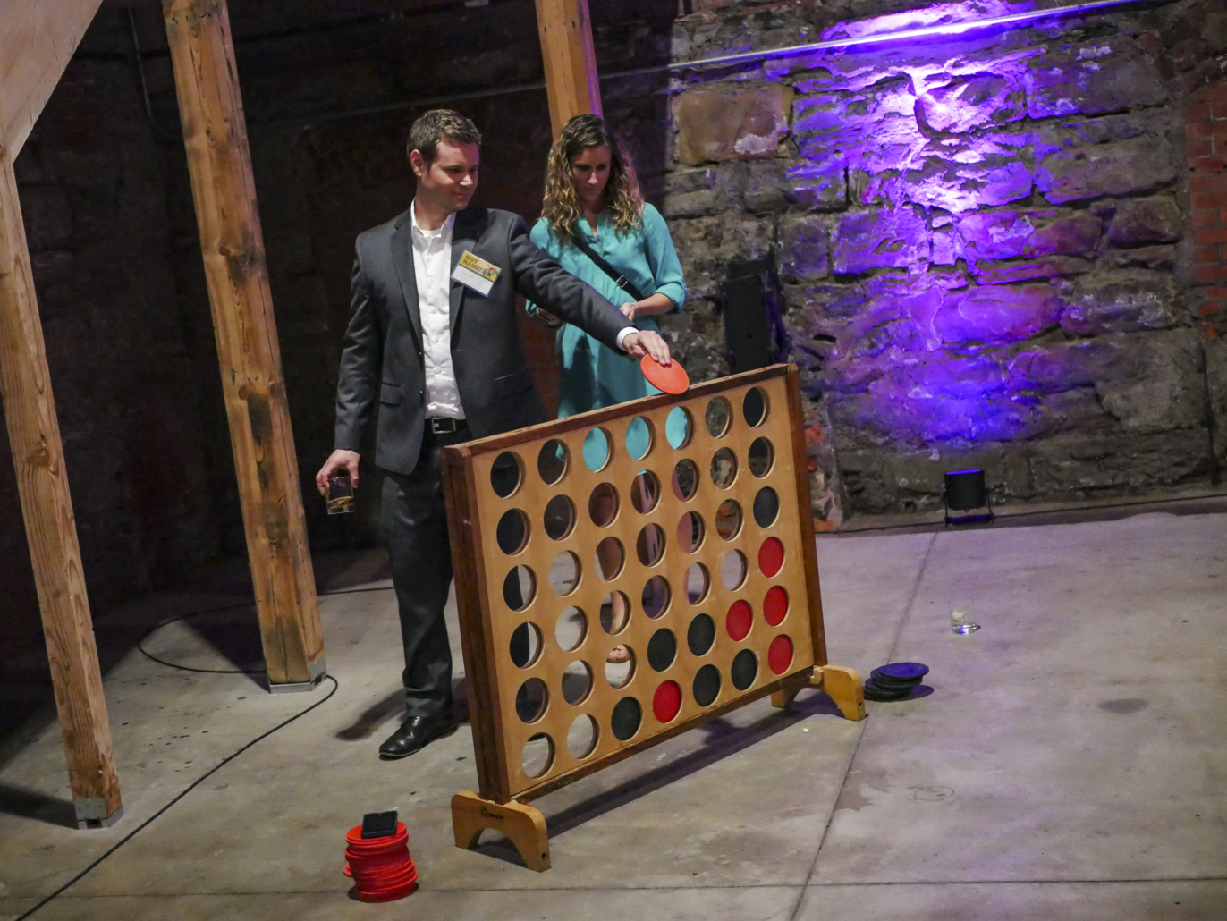Image of two adults playing Giant Connect 4